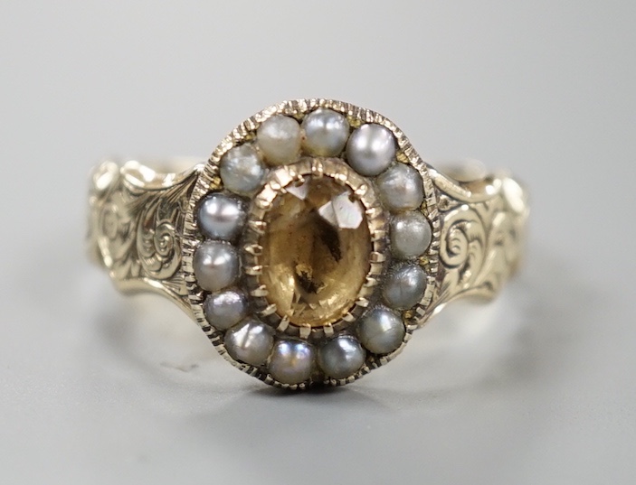 An early 19th century engraved yellow metal, citrine and seed pearl set oval cluster ring, size R, gross weight 3.7 grams.